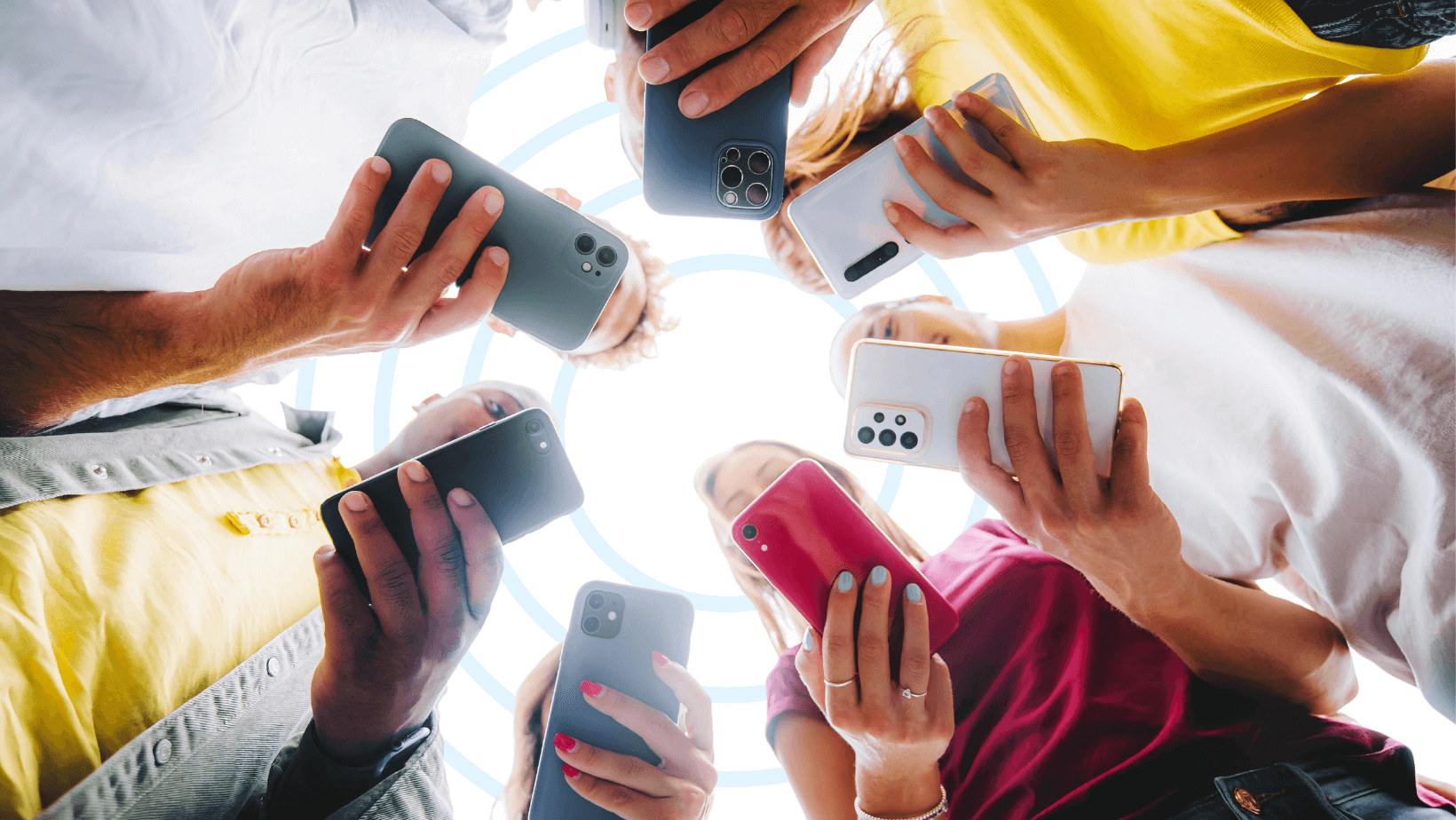 Group of people holding smartphones, discussing EMF Protection for Phone and its effects on brain power.