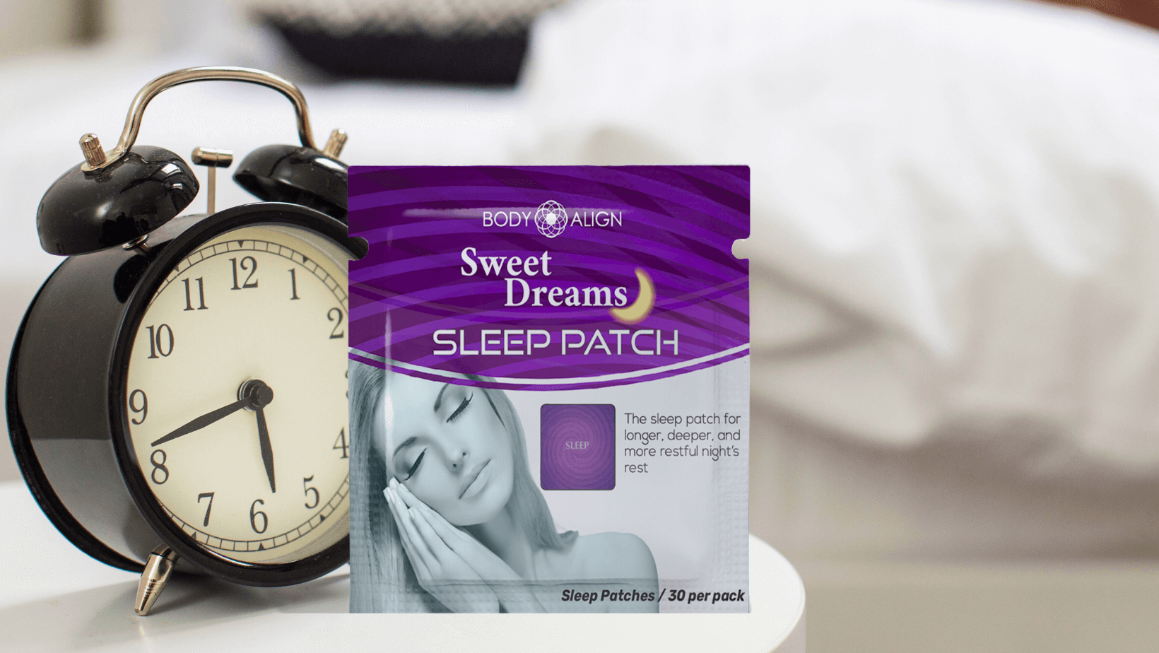 Sweet Dreams Sleep Patch on a bedside table next to an alarm clock for better sleep, featured in Sleep, Music & Meditation: Real Secrets for Better Rest.