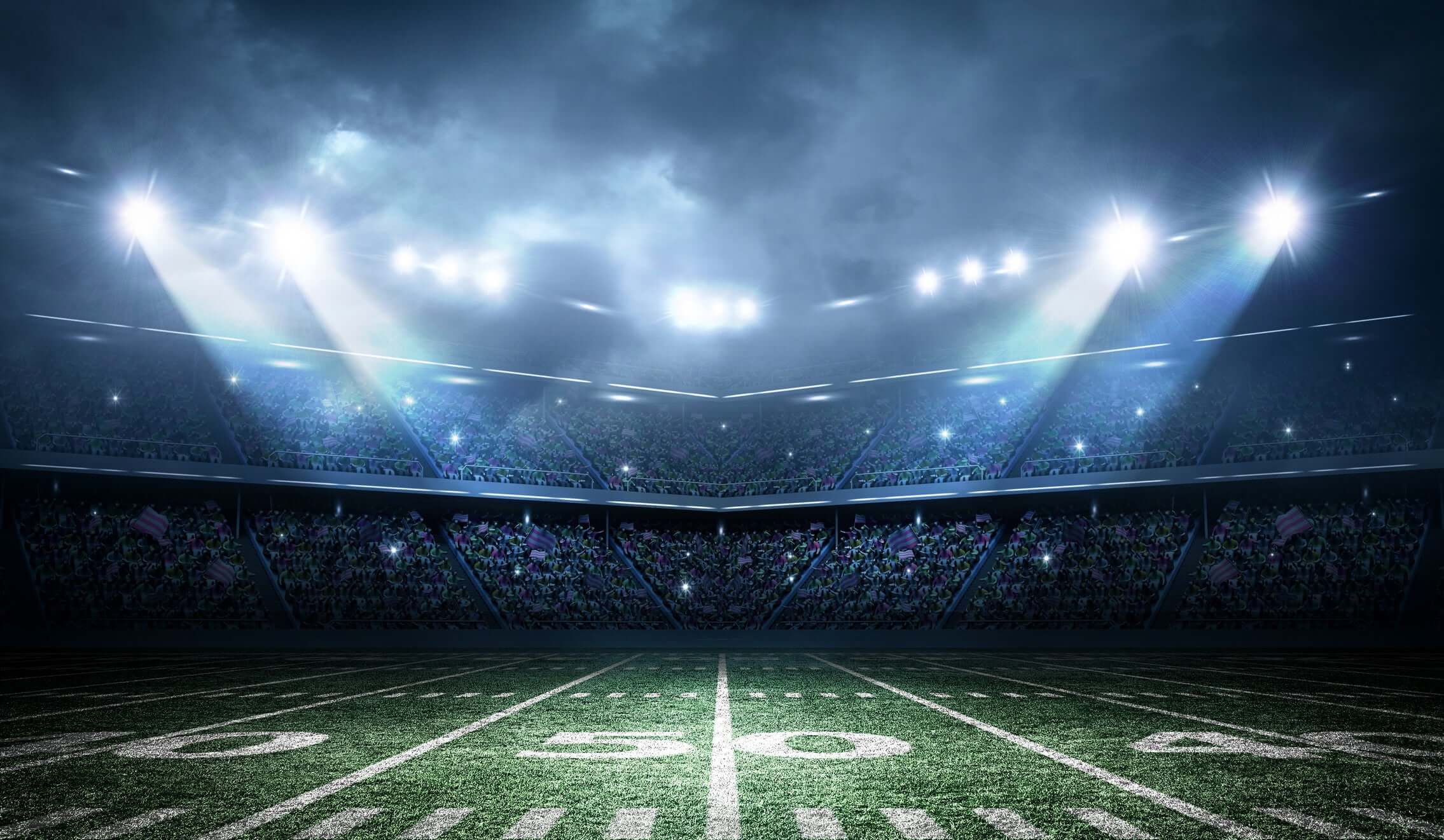 Stadium field illuminated with bright lights, showcasing excitement for sports events like the Donovan McNabb Body Align partnership.