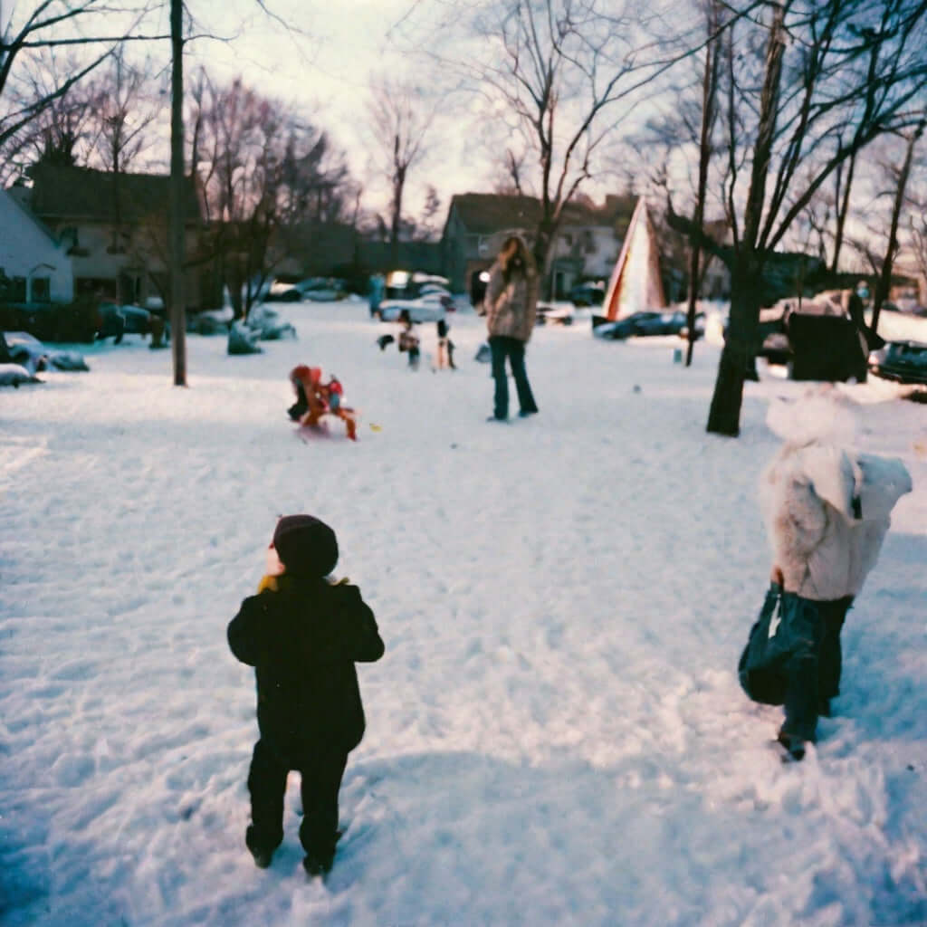 Children playing in a snowy neighborhood during winter, capturing the joy of the holiday season.
