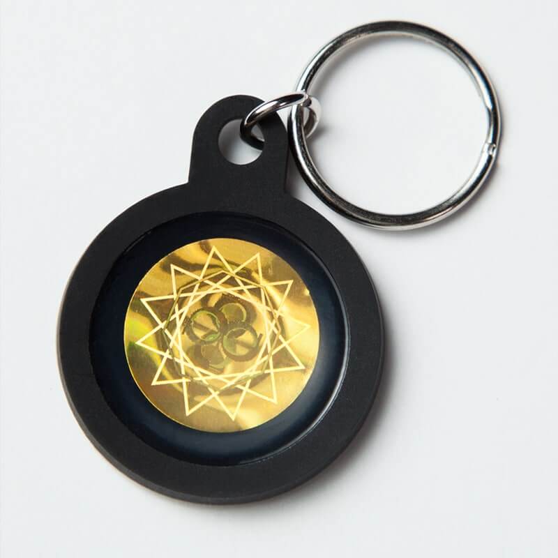 Pet EMF Protection Tag on a keychain with a golden design.