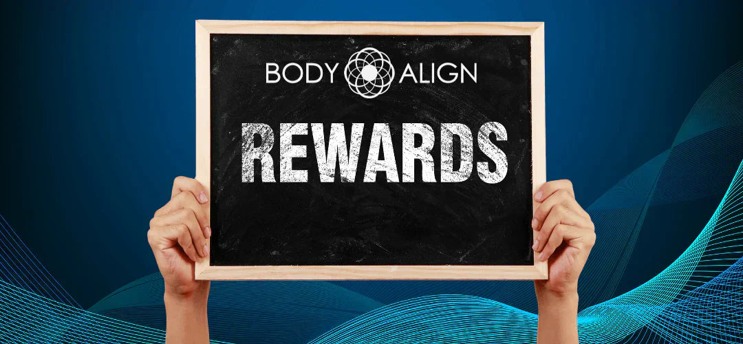 Hands holding a chalkboard sign saying 'Rewards' promoting Energy Wellness Rewards program.
