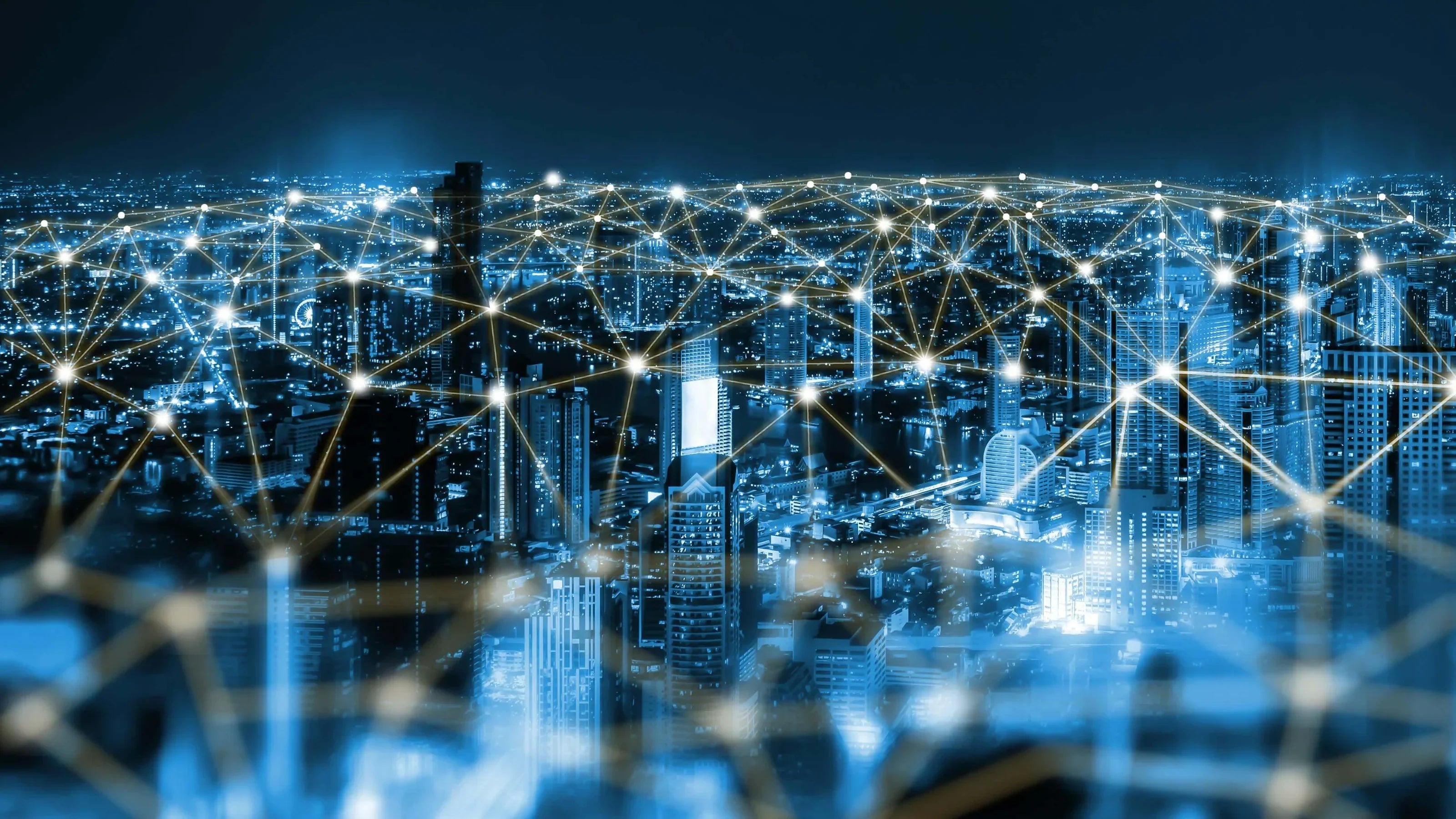 A city skyline illuminated at night with a network of connections, representing chronic EMF exposure.