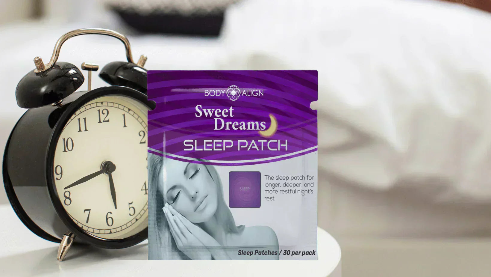 Better sleep with Body Align Sweet Dreams Sleep Patch shown beside an alarm clock on a bedside table.