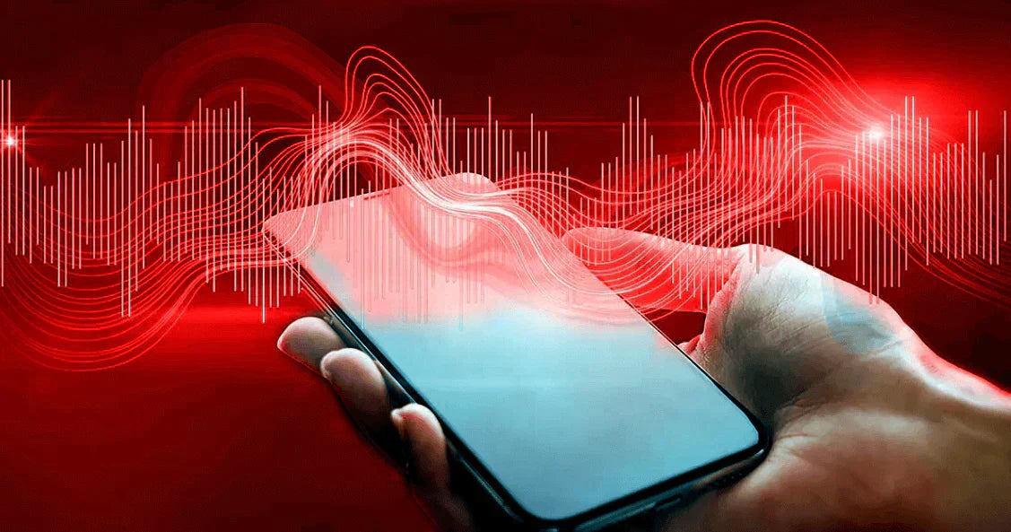 Close-up of a hand holding a smartphone with EMFs and Your Health visualizations in red background.