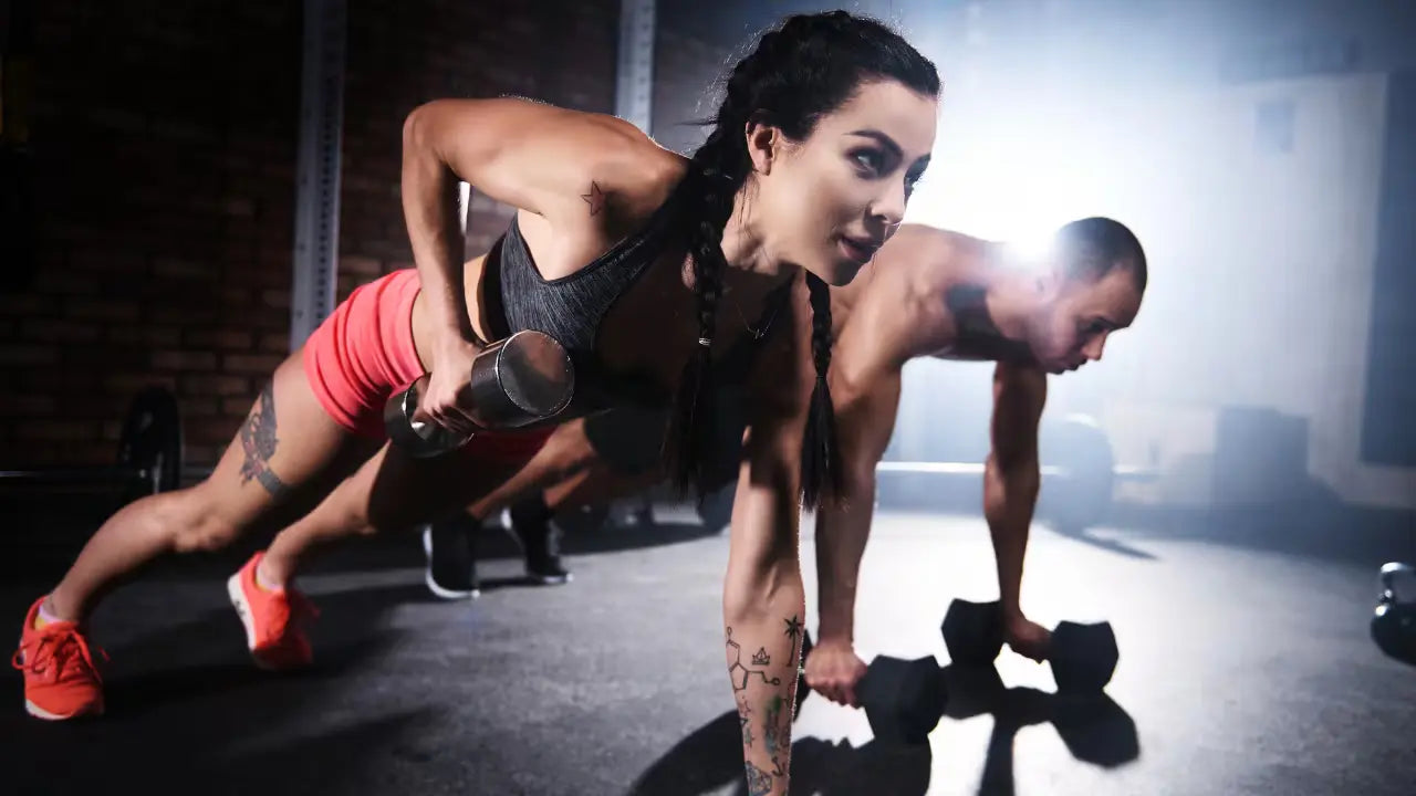 Workout motivation secrets: A determined woman works out with dumbbells in a gym setting.