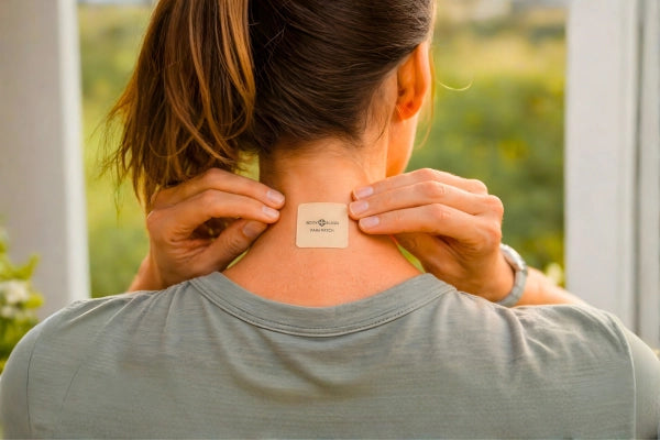 Person wearing a Body Align Pain Patch on their back